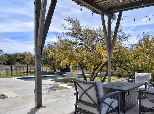 view of patio / terrace featuring a fenced backyard, a fenced in pool, and outdoor dining space