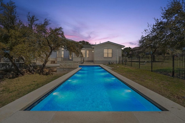 view of swimming pool with a lawn, a fenced in pool, and fence