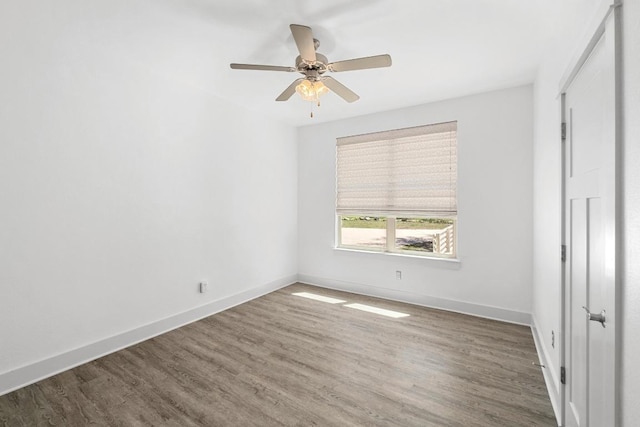 unfurnished bedroom featuring ceiling fan, baseboards, and wood finished floors