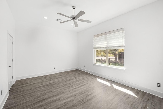 spare room with visible vents, baseboards, dark wood finished floors, recessed lighting, and ceiling fan