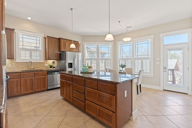 3129 Mill Stream Dr, Cedar Park, TX 78613 - kitchen with stainless steel appliances, brown cabinetry, light tile patterned floors, and recessed lighting