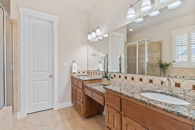 full bathroom with a shower stall, tile patterned floors, tasteful backsplash, vanity, and baseboards