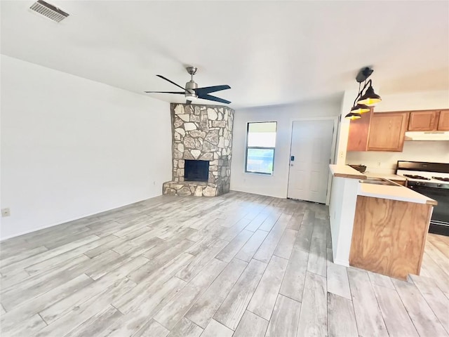 809 Bracewood Cir, San Marcos, TX 78666 - kitchen featuring a ceiling fan, gas stove, visible vents, light countertops, and open floor plan