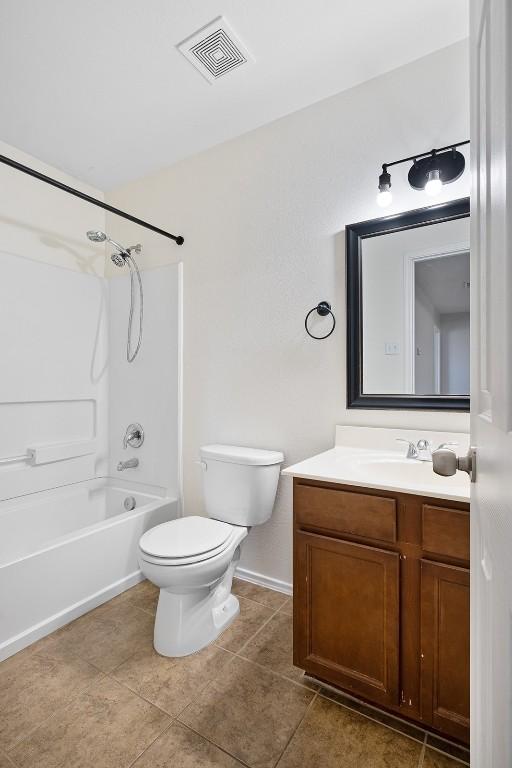 100 Snowy Egret Ln, Leander, TX 78641 - bathroom with toilet, vanity, bathing tub / shower combination, tile patterned flooring, and baseboards