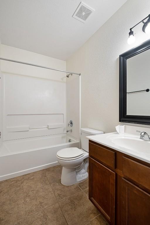 100 Snowy Egret Ln, Leander, TX 78641 - full bathroom featuring vanity, shower / tub combination, toilet, and tile patterned floors