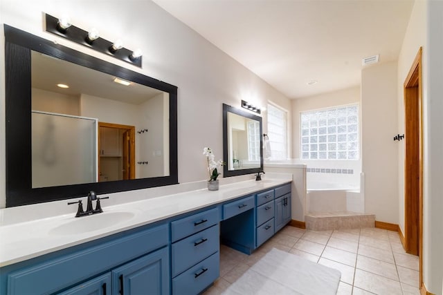 212 Cassidy Dr S, Georgetown, TX 78628 - bathroom featuring double vanity, a bath, tile patterned flooring, an enclosed shower, and baseboards