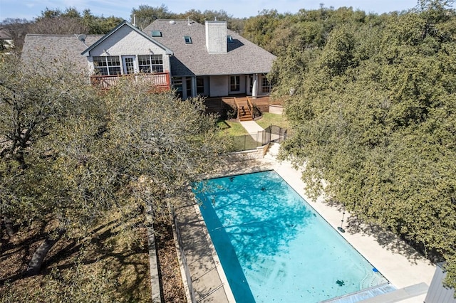 212 Cassidy Dr S, Georgetown, TX 78628 - back of property featuring a wooden deck, an outdoor pool, and a chimney
