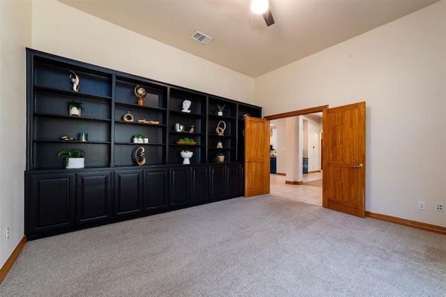 spare room with visible vents, baseboards, and light colored carpet