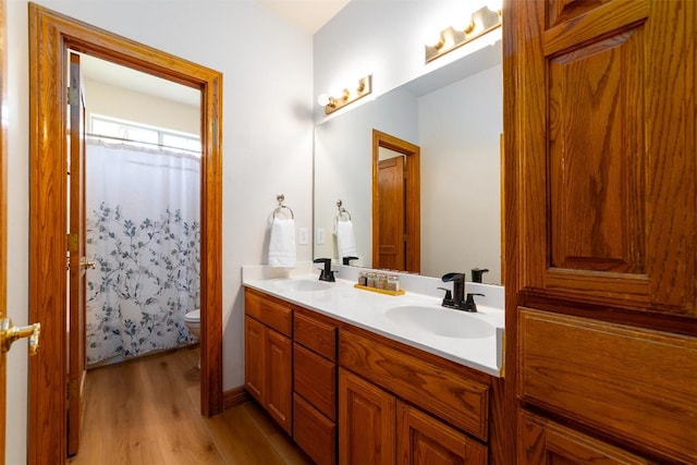 212 Cassidy Dr S, Georgetown, TX 78628 - bathroom with toilet, wood finished floors, double vanity, and a shower with curtain