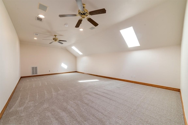 bonus room with visible vents, lofted ceiling with skylight, carpet floors, and baseboards