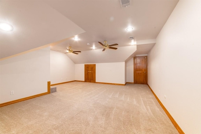 bonus room featuring visible vents, light colored carpet, lofted ceiling, and baseboards