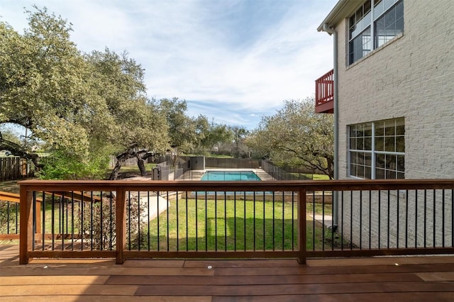 wooden terrace featuring a fenced in pool, a yard, and fence