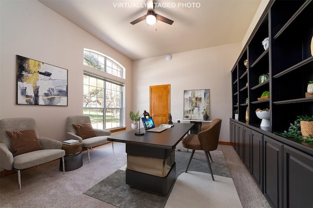 office featuring a ceiling fan, baseboards, and light carpet