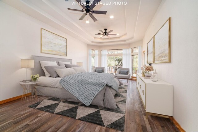 212 Cassidy Dr S, Georgetown, TX 78628 - bedroom featuring wood finished floors, baseboards, a tray ceiling, and recessed lighting