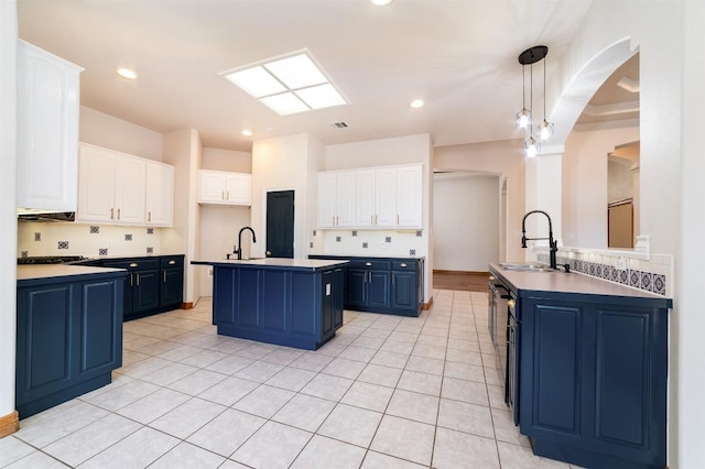 212 Cassidy Dr S, Georgetown, TX 78628 - kitchen featuring a sink, blue cabinetry, an island with sink, white cabinets, and recessed lighting