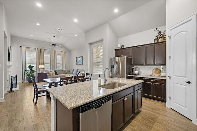 kitchen featuring visible vents, ceiling fan, a sink, vaulted ceiling, and appliances with stainless steel finishes