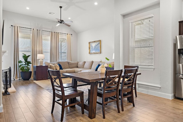 dining space featuring visible vents, ceiling fan, light wood-type flooring, vaulted ceiling, and recessed lighting