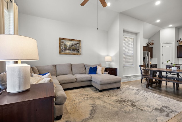 living area featuring vaulted ceiling, recessed lighting, wood finished floors, and ceiling fan