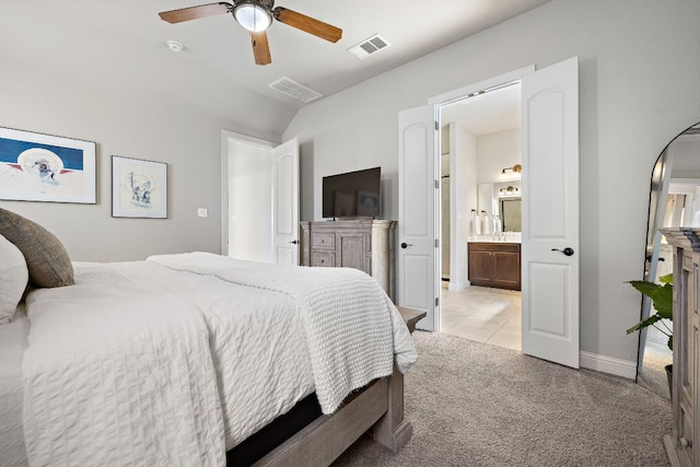 bedroom featuring visible vents, connected bathroom, baseboards, light carpet, and light tile patterned floors