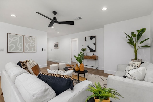 living room with visible vents, recessed lighting, a ceiling fan, and wood finished floors