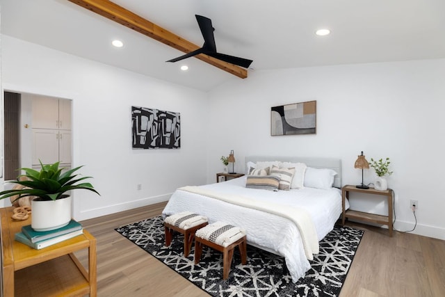 bedroom featuring lofted ceiling with beams, recessed lighting, wood finished floors, and baseboards