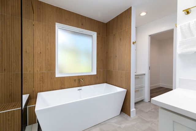 full bathroom featuring vanity, recessed lighting, and a freestanding bath