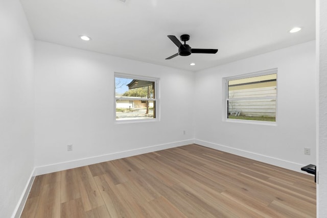 spare room with recessed lighting, a ceiling fan, baseboards, and light wood finished floors