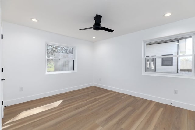 unfurnished room with plenty of natural light, light wood-style floors, and baseboards