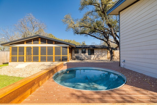 view of swimming pool featuring a sunroom