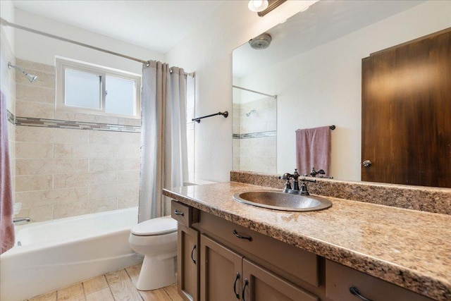 full bathroom with vanity, toilet, wood finished floors, and shower / tub combo