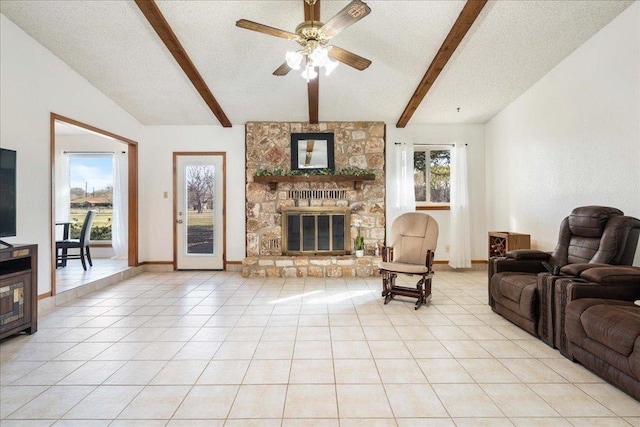 living room with light tile patterned floors, a large fireplace, plenty of natural light, and a ceiling fan