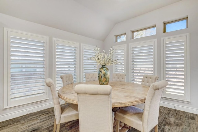 dining area with a wealth of natural light, lofted ceiling, and wood finished floors