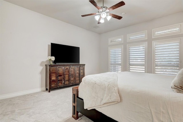 carpeted bedroom with a ceiling fan and baseboards