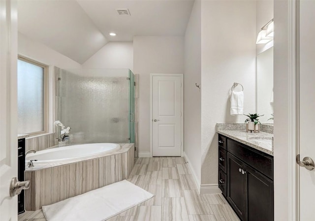 full bath with visible vents, a shower stall, baseboards, a garden tub, and vanity