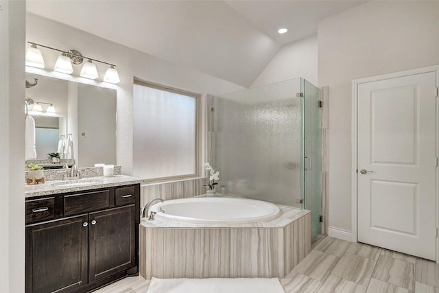 full bathroom with vanity, a garden tub, a stall shower, and vaulted ceiling