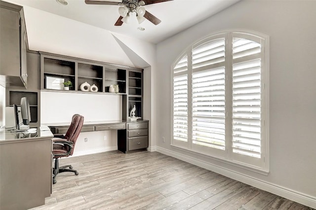 office area with baseboards, ceiling fan, and light wood finished floors