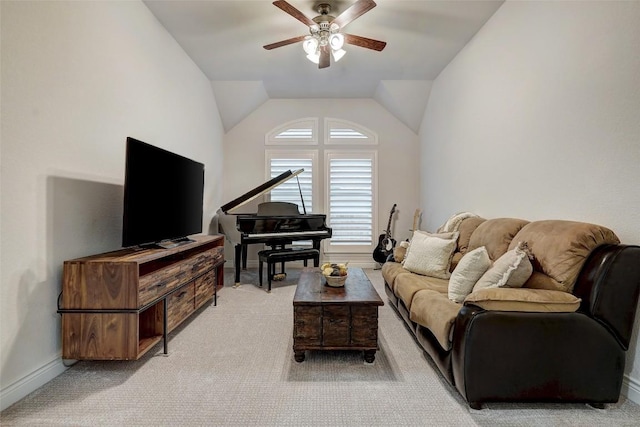 living room featuring baseboards, lofted ceiling, light colored carpet, and a ceiling fan