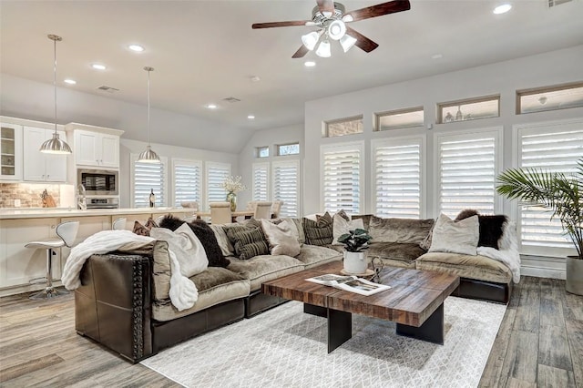 living area featuring recessed lighting, a ceiling fan, visible vents, and light wood finished floors