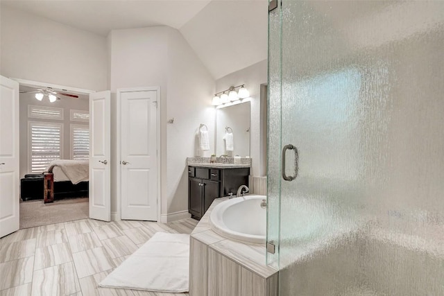 bathroom with a shower stall, a garden tub, lofted ceiling, ensuite bath, and a ceiling fan