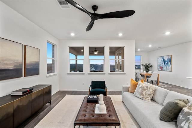 living area featuring recessed lighting, visible vents, ceiling fan, and dark wood-style flooring