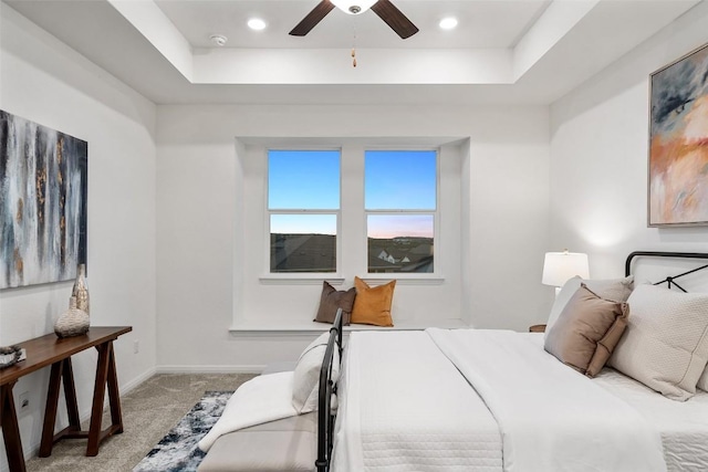 carpeted bedroom with recessed lighting, a tray ceiling, baseboards, and ceiling fan