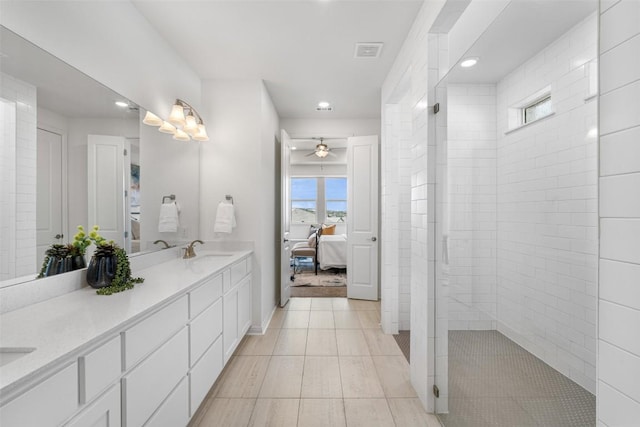 full bathroom with a ceiling fan, double vanity, a sink, ensuite bathroom, and walk in shower