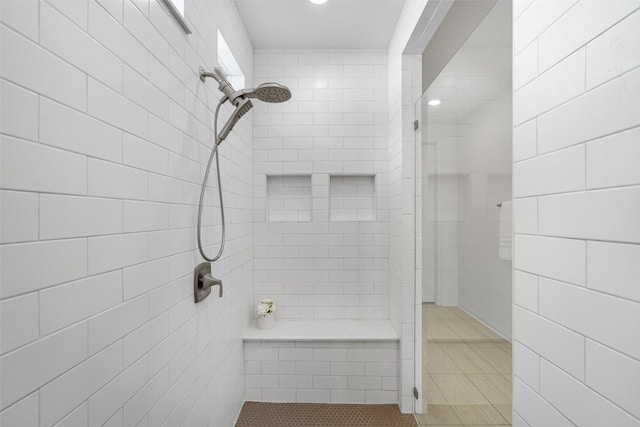 bathroom with tiled shower