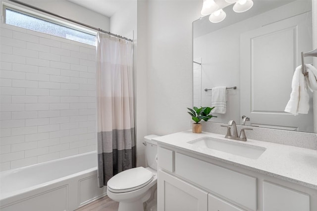 bathroom with toilet, shower / tub combo with curtain, and vanity