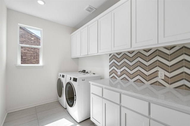 clothes washing area featuring visible vents, washer and dryer, recessed lighting, cabinet space, and baseboards