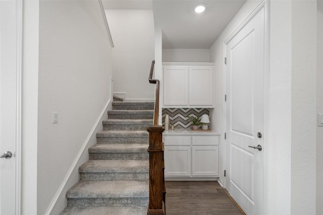 stairs with recessed lighting, baseboards, and wood finished floors