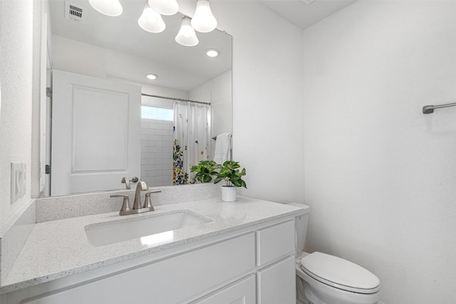 bathroom with vanity, toilet, a shower with curtain, and visible vents