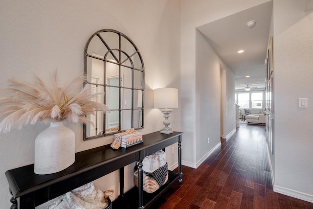 hallway featuring recessed lighting, wood finished floors, and baseboards