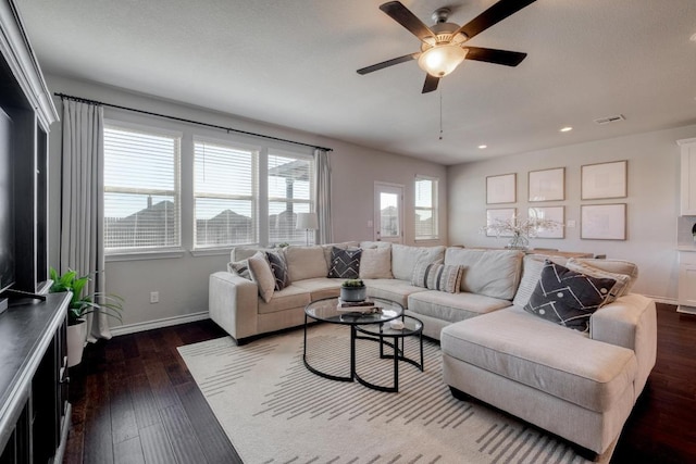 living area featuring a ceiling fan, visible vents, baseboards, recessed lighting, and dark wood-style flooring