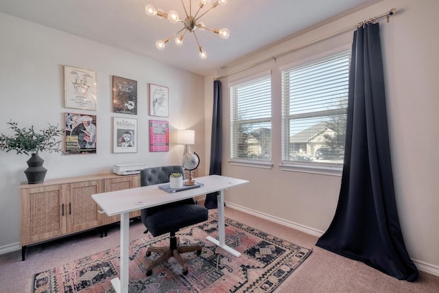 office area featuring light carpet, baseboards, and a chandelier